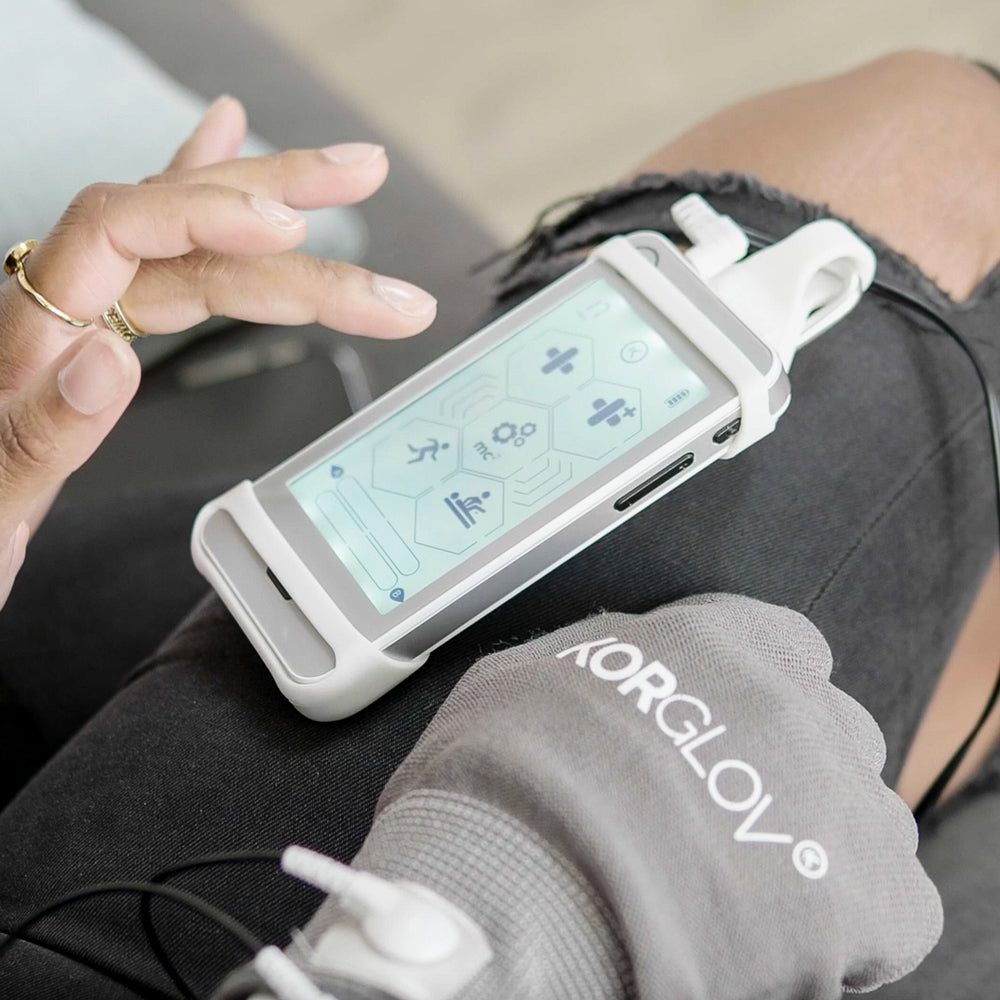 nurokor mitouch device in hand, korglov accessory showing uses and functions, microcurrent, pns, nms,